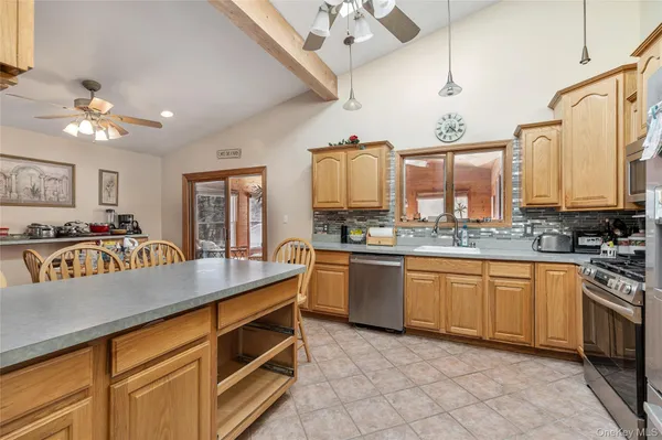 a kitchen with stainless steel appliances granite countertop a sink and cabinets