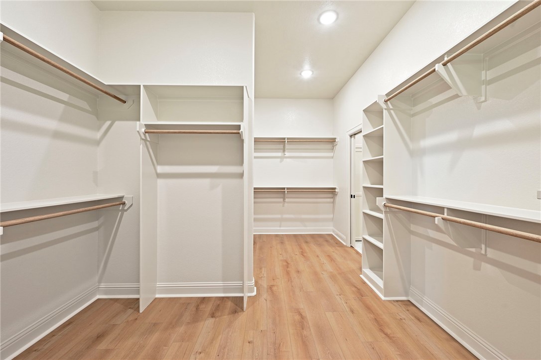 7052 Skipping Rock Path Bryan, TX 77808 - Photo 13 of 23 a view of walk in closet with empty racks