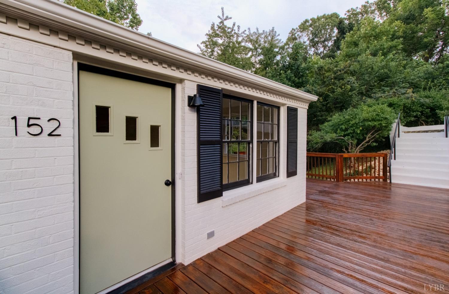 a view of a balcony with floor to ceiling window and wooden floor