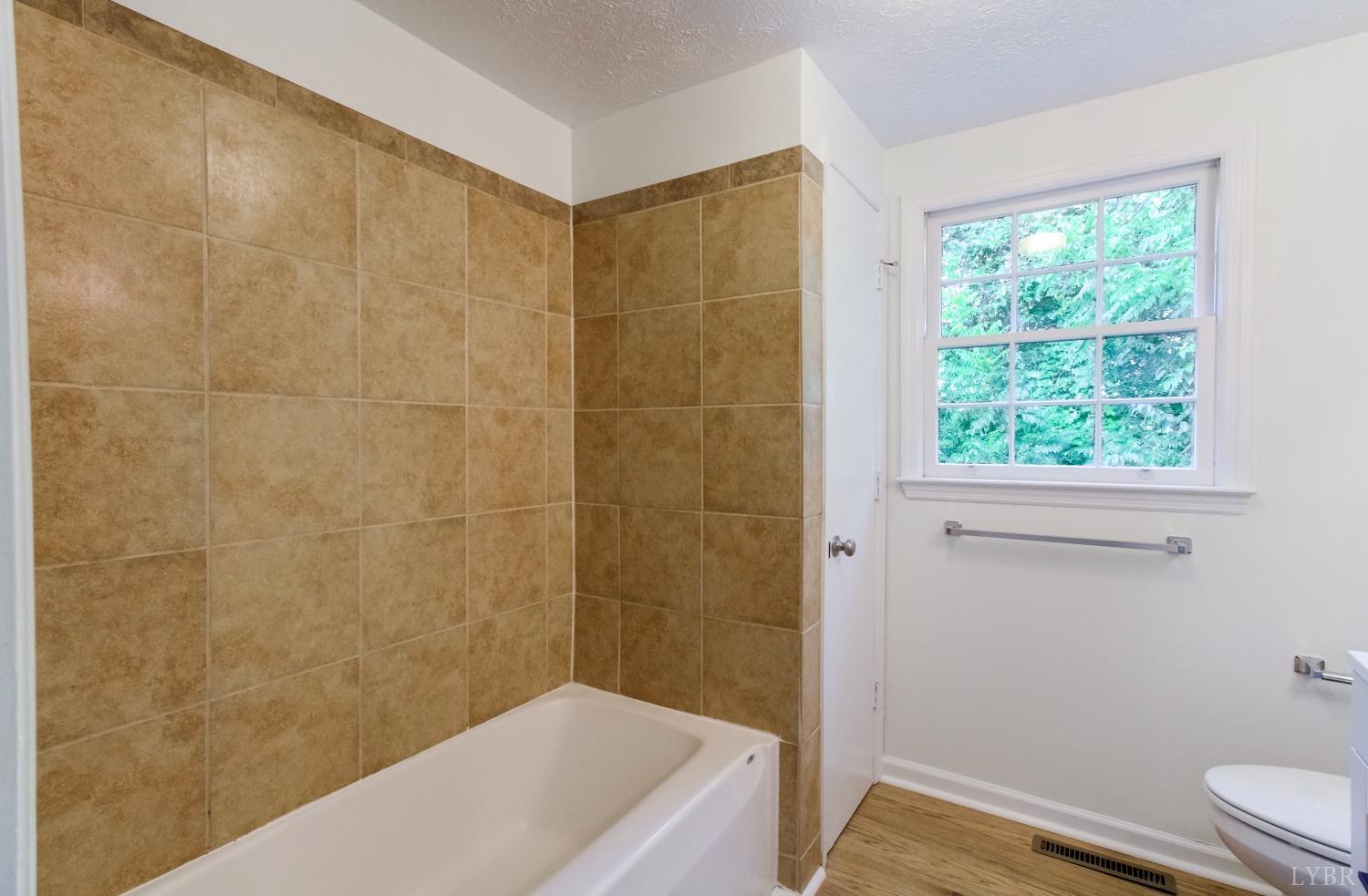 152 Hanger Road Amherst, VA 24521 - Photo 12 of 27 a bathroom with a bathtub and a window
