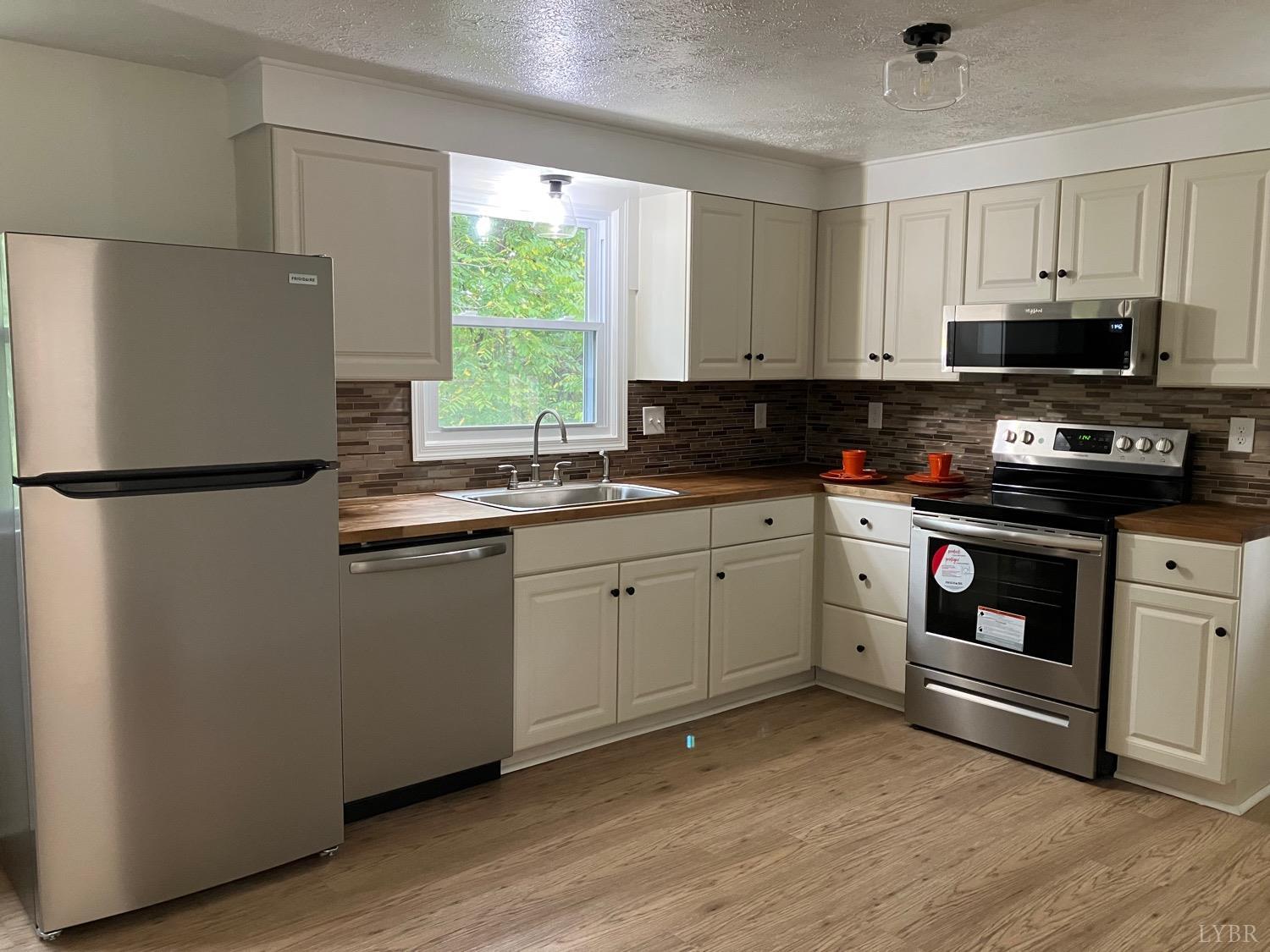 152 Hanger Road Amherst, VA 24521 - Photo 7 of 27 a kitchen with stainless steel appliances a stove a sink and a refrigerator