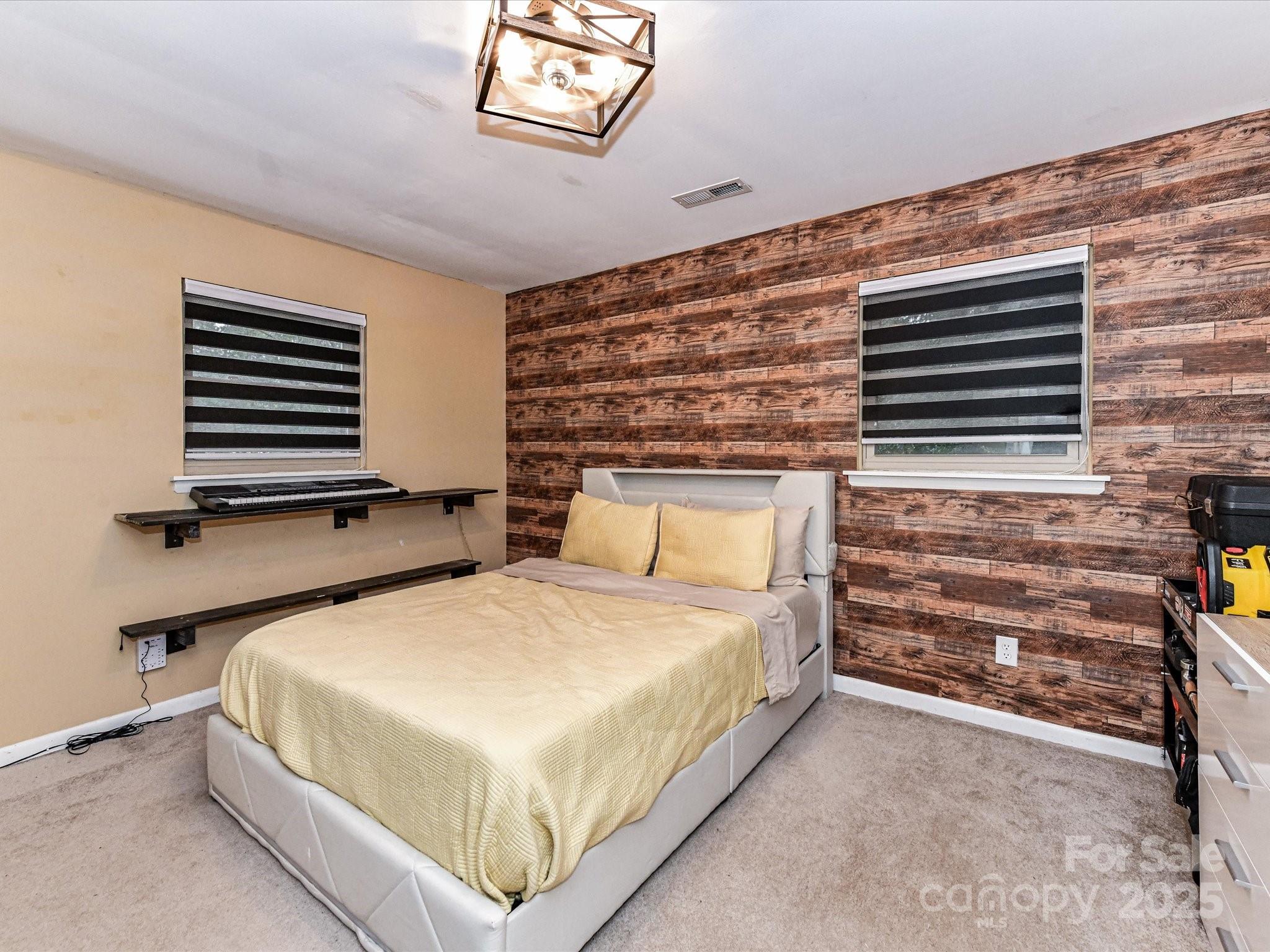 4500 Matthews-Mint Hill Road Matthews, NC 28105 - Photo 23 of 40 a bedroom with a bed and a dresser