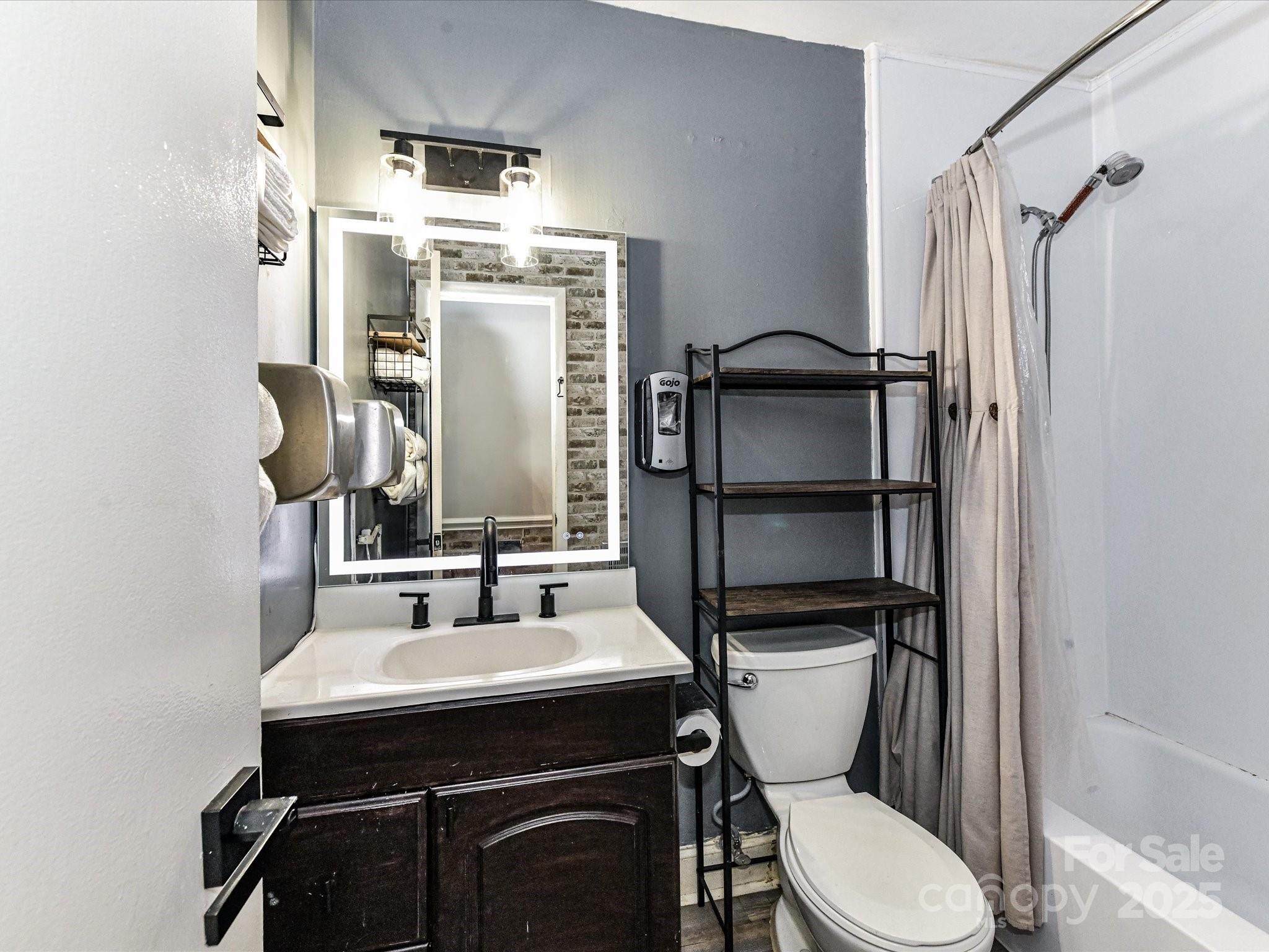 4500 Matthews-Mint Hill Road Matthews, NC 28105 - Photo 24 of 40 a bathroom with a sink toilet vanity and shower