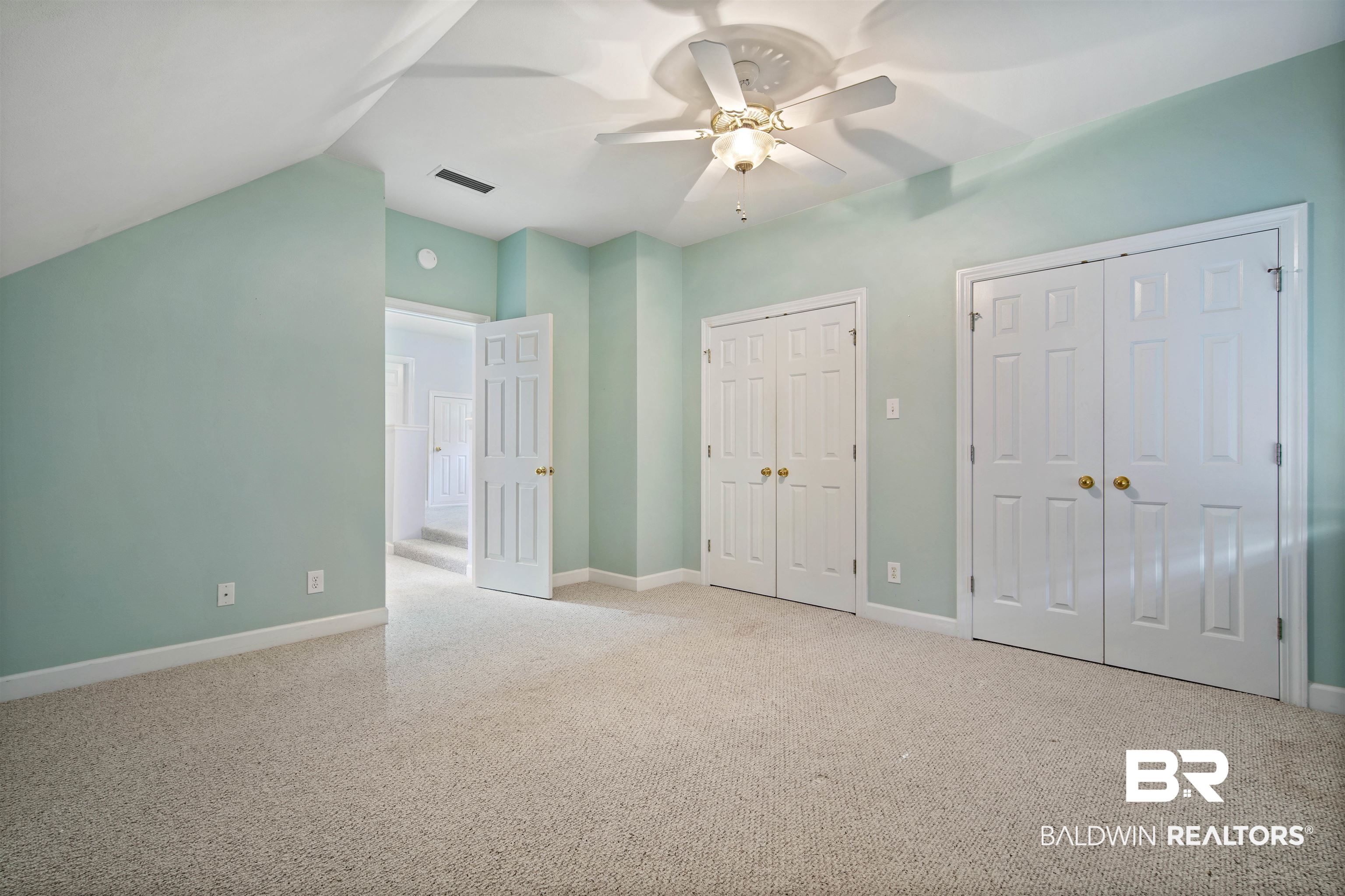 204 General Canby Loop Daphne, AL 36527 - Photo 22 of 36 Unfurnished bedroom with ceiling fan, lofted ceiling, two closets, and light carpet