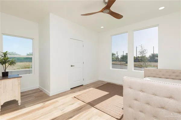 a living room with a bed furniture and next to a window