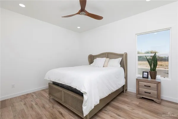 a bedroom with a bed and a night stand
