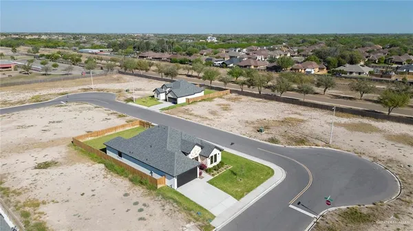 an aerial view of a house with a yard and lake view
