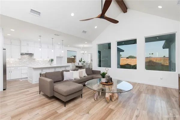 a living room with stainless steel appliances kitchen island granite countertop furniture and a view of kitchen