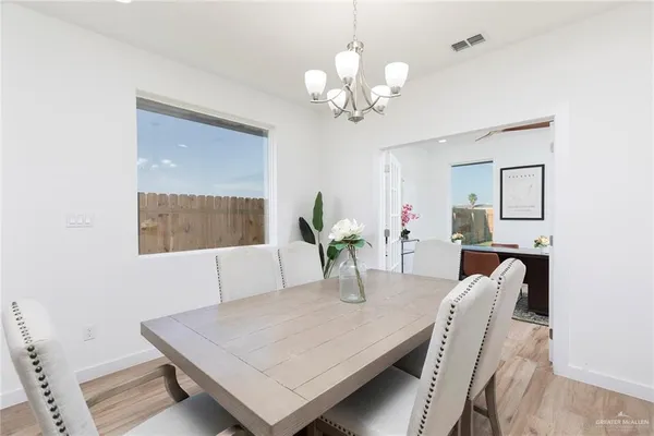 a view of a dining room with furniture and chandelier