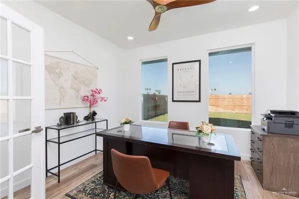 a kitchen with a sink and a stove top oven with wooden floor