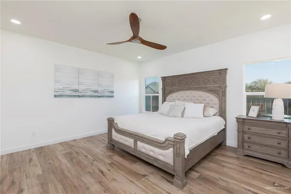 a bedroom with a bed and cabinet