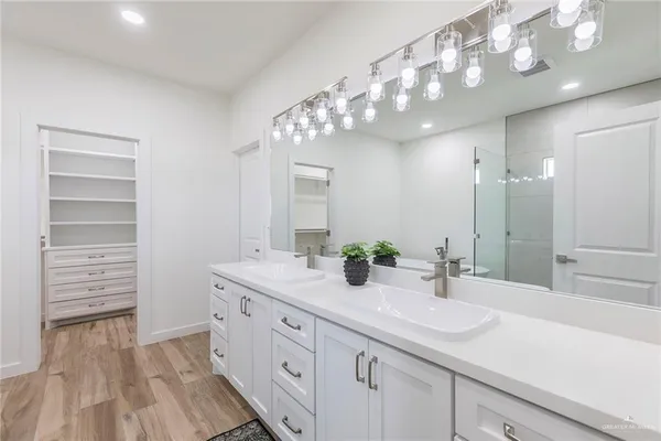 a bathroom with a sink double vanity and a mirror