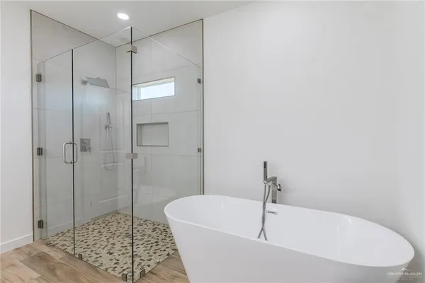 a white bath tub sitting next to a shower