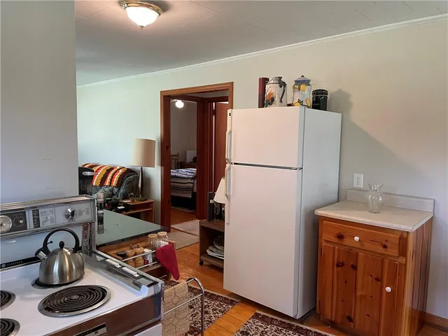 a living room with furniture a flat screen tv and a window
