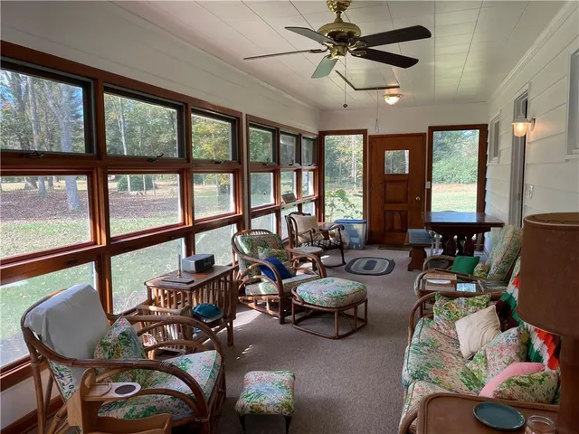 a living room with furniture a flat screen tv and a window