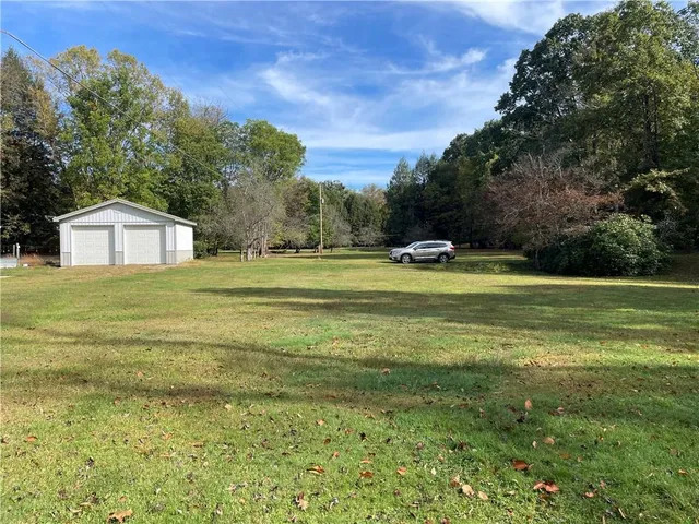 a view of a swimming pool with an outdoor seating and a yard