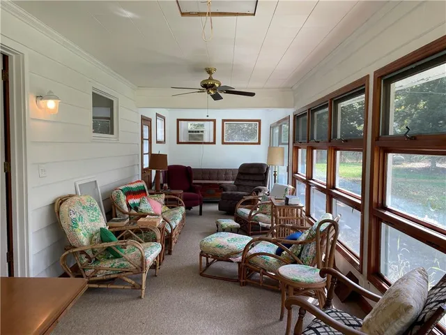 a living room with a bed and a dresser
