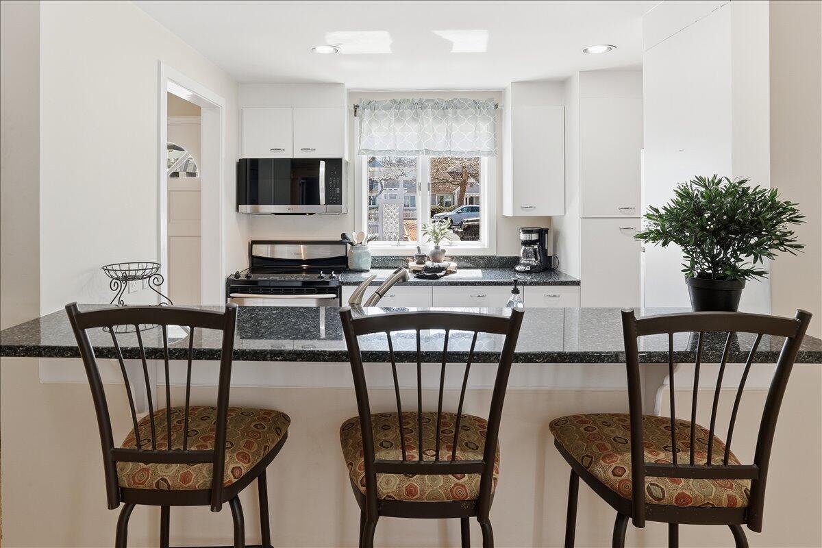 100 Mid-Iron Way, Unit 7027 Mashpee, MA 02649 - Photo 5 of 38 a view of a dining room with furniture window and wooden floor