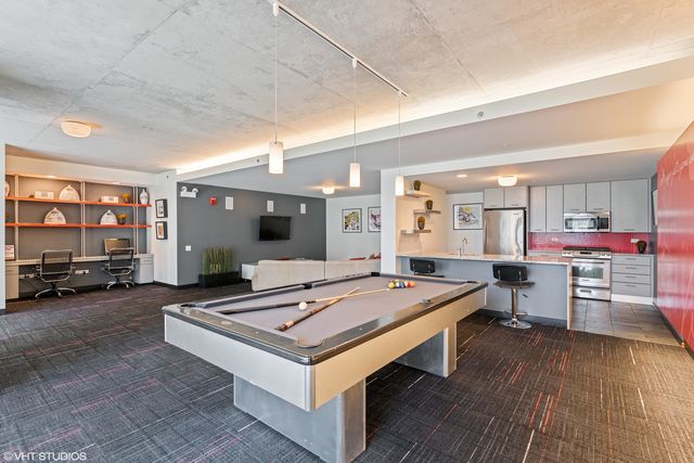a room with pool table and flat screen tv