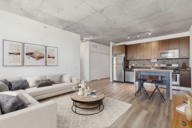 a living room with furniture and kitchen view