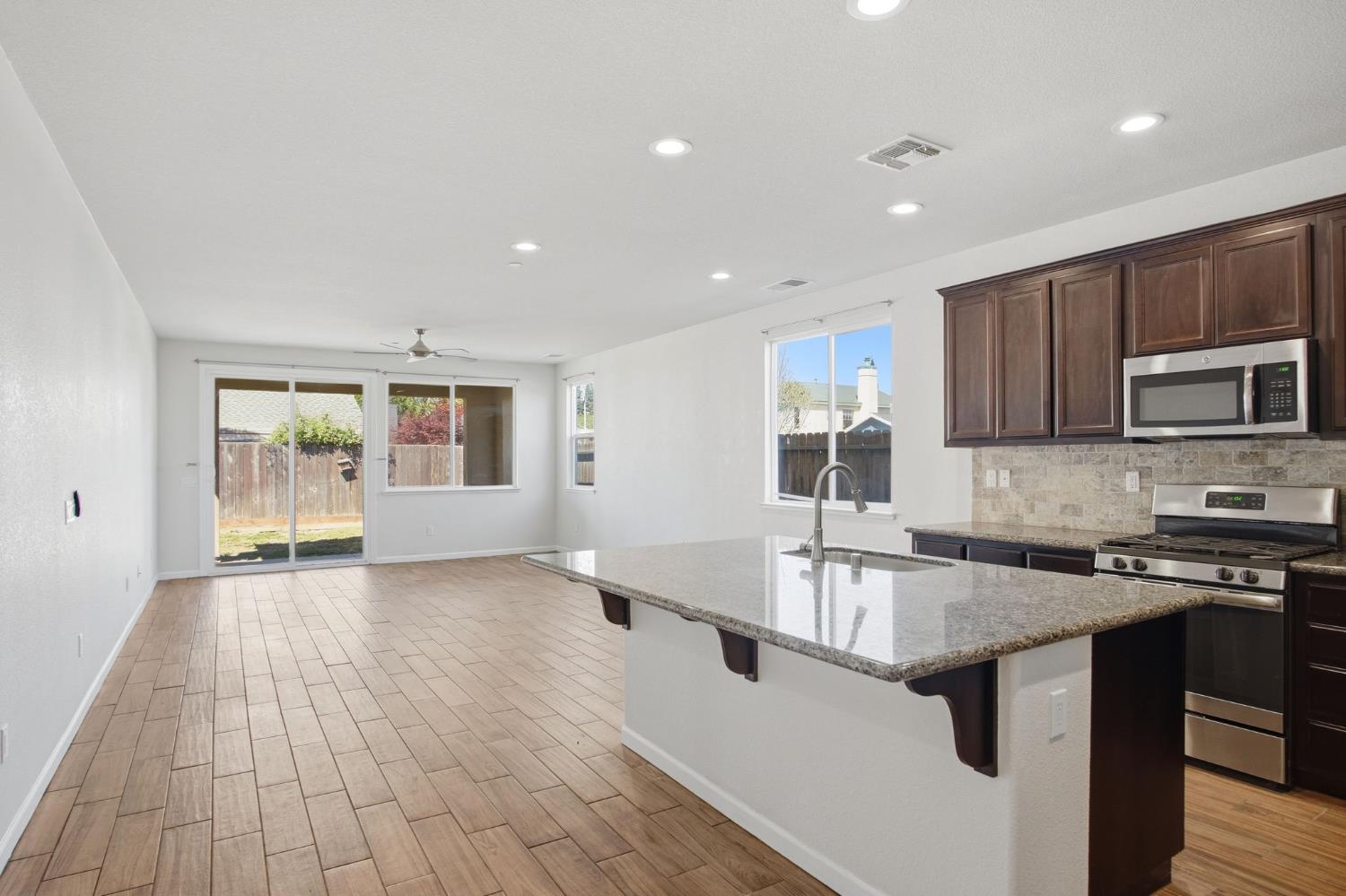 4113 Snowfire Drive Modesto, CA 95357 - Photo 4 of 19 a kitchen with stainless steel appliances granite countertop a sink stove and microwave