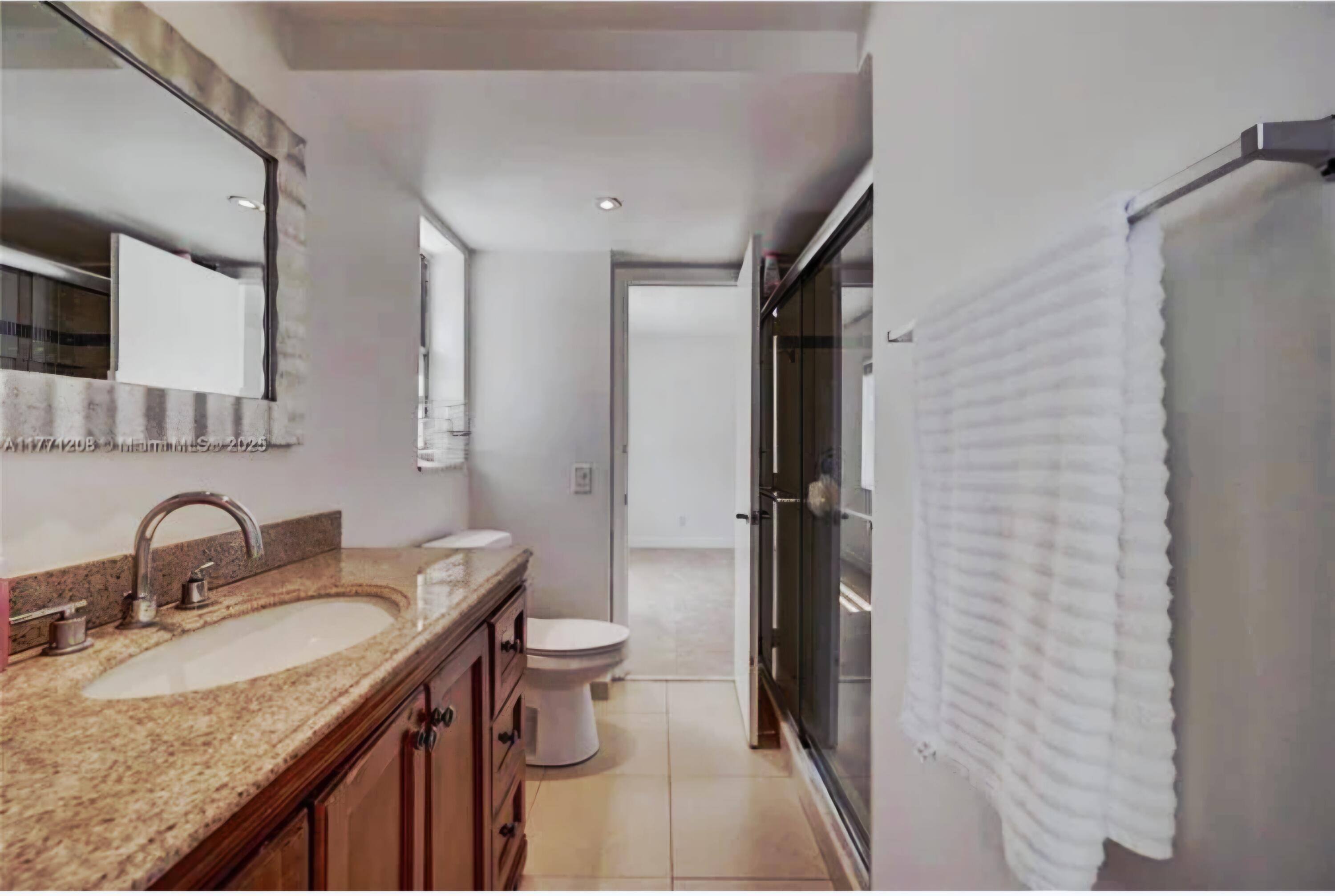 200 South Birch Road, Unit 208 Fort Lauderdale, FL 33316 - Photo 18 of 22 a bathroom with a granite countertop sink toilet and shower