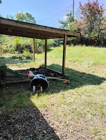 a view of a backyard of a house with a yard