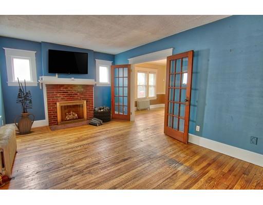 141 Dwight Road Springfield, MA 01108 - Photo 4 of 12 a view of empty room with wooden floor and fireplace