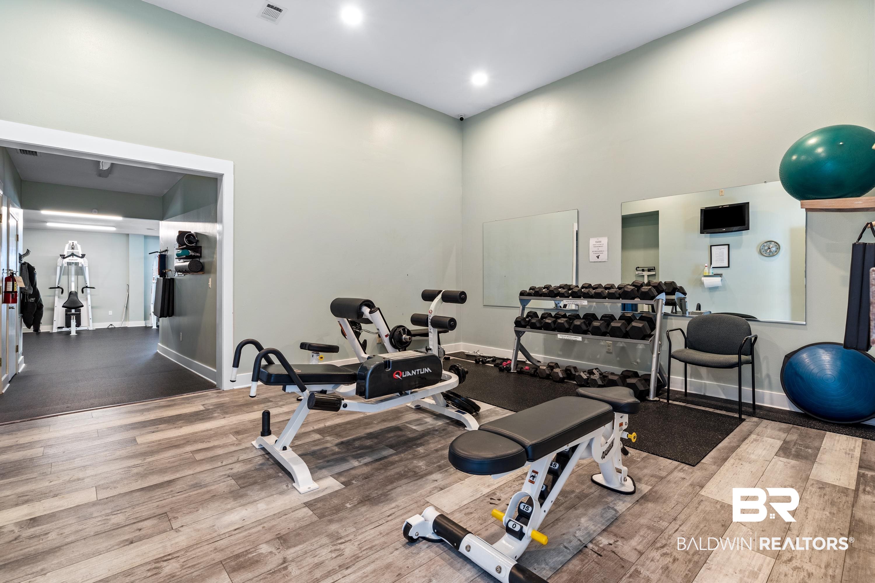 30194 River Road Orange Beach, AL 36561 - Photo 43 of 45 Fitness area featuring wood-finish flooring and light-toned walls