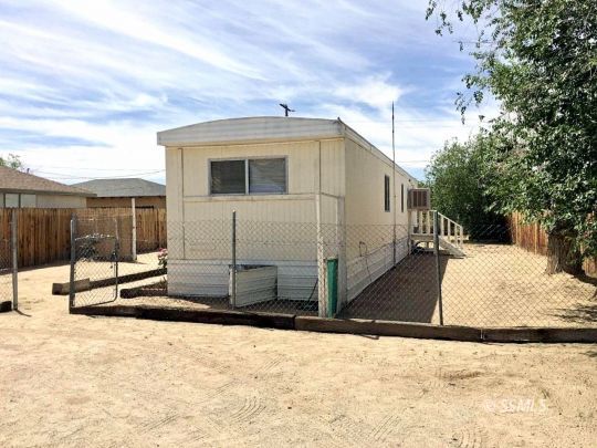 709 West Reeves Avenue Ridgecrest, CA 93555 - Photo 13 of 14 a view of a house with a snow in the background