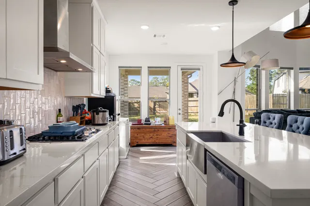 a kitchen with stainless steel appliances granite countertop a sink and a stove