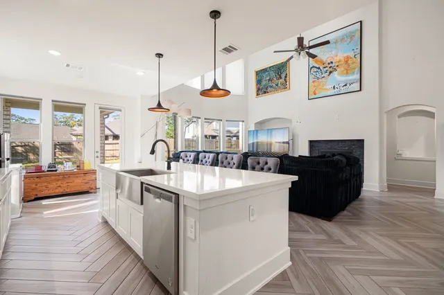 a kitchen with stainless steel appliances granite countertop a stove a sink and a refrigerator