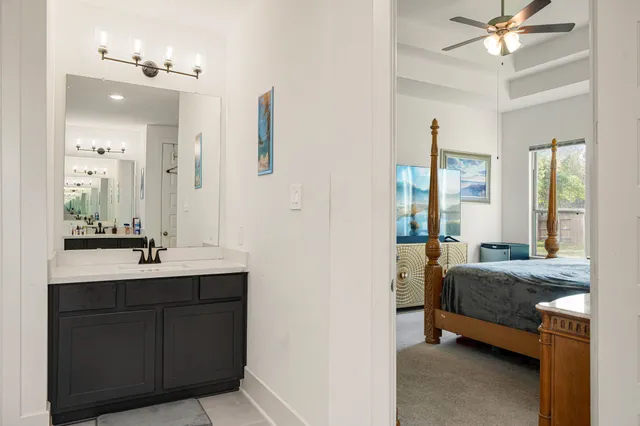a en suite bathroom with a double vanity sink a mirror and a shower