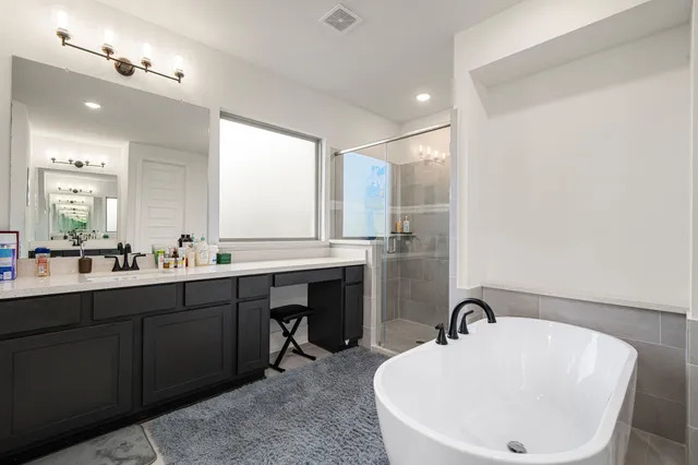 a bathroom with a double vanity sink and a bathtub
