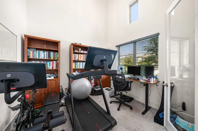 a view of a workspace with furniture and a window