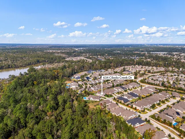 an aerial view of residential building and trees around
