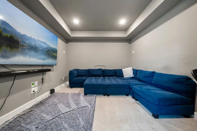a living room with furniture and a ceiling fan