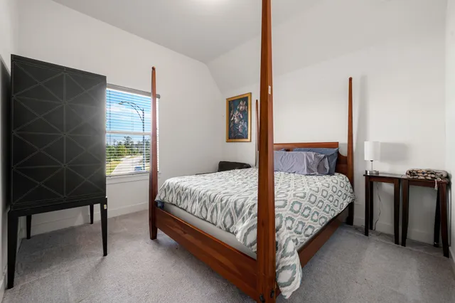 a bedroom with a bed and a desk in it