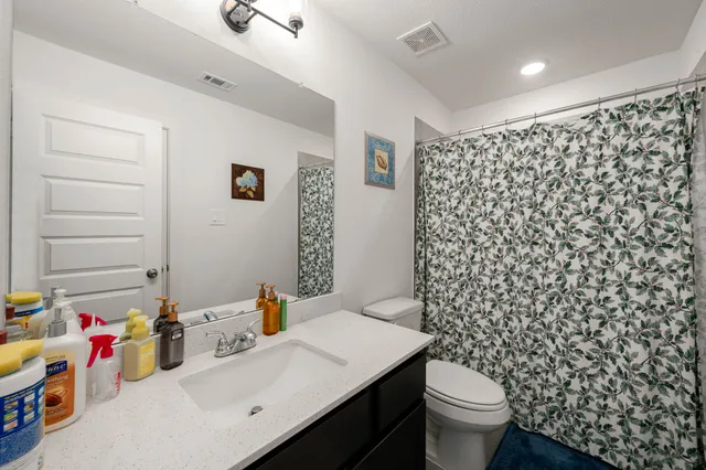 a bathroom with a sink toilet and shower