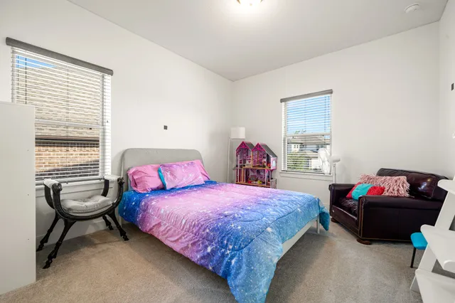 a bedroom with two beds and a window