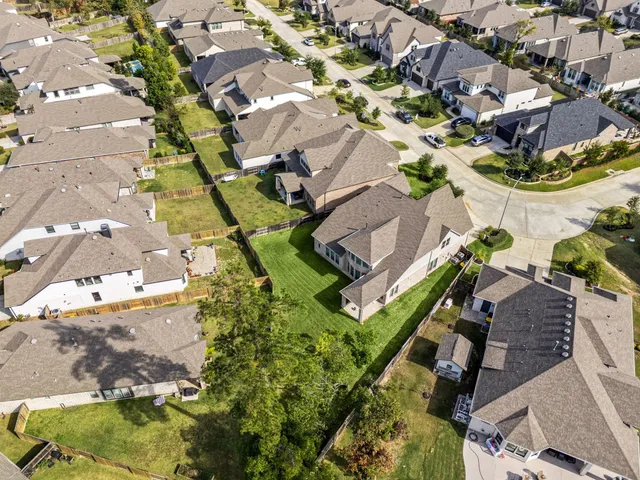 an aerial view of residential houses with outdoor space