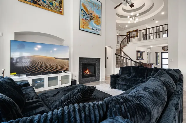 a living room with furniture a fireplace and a flat screen tv