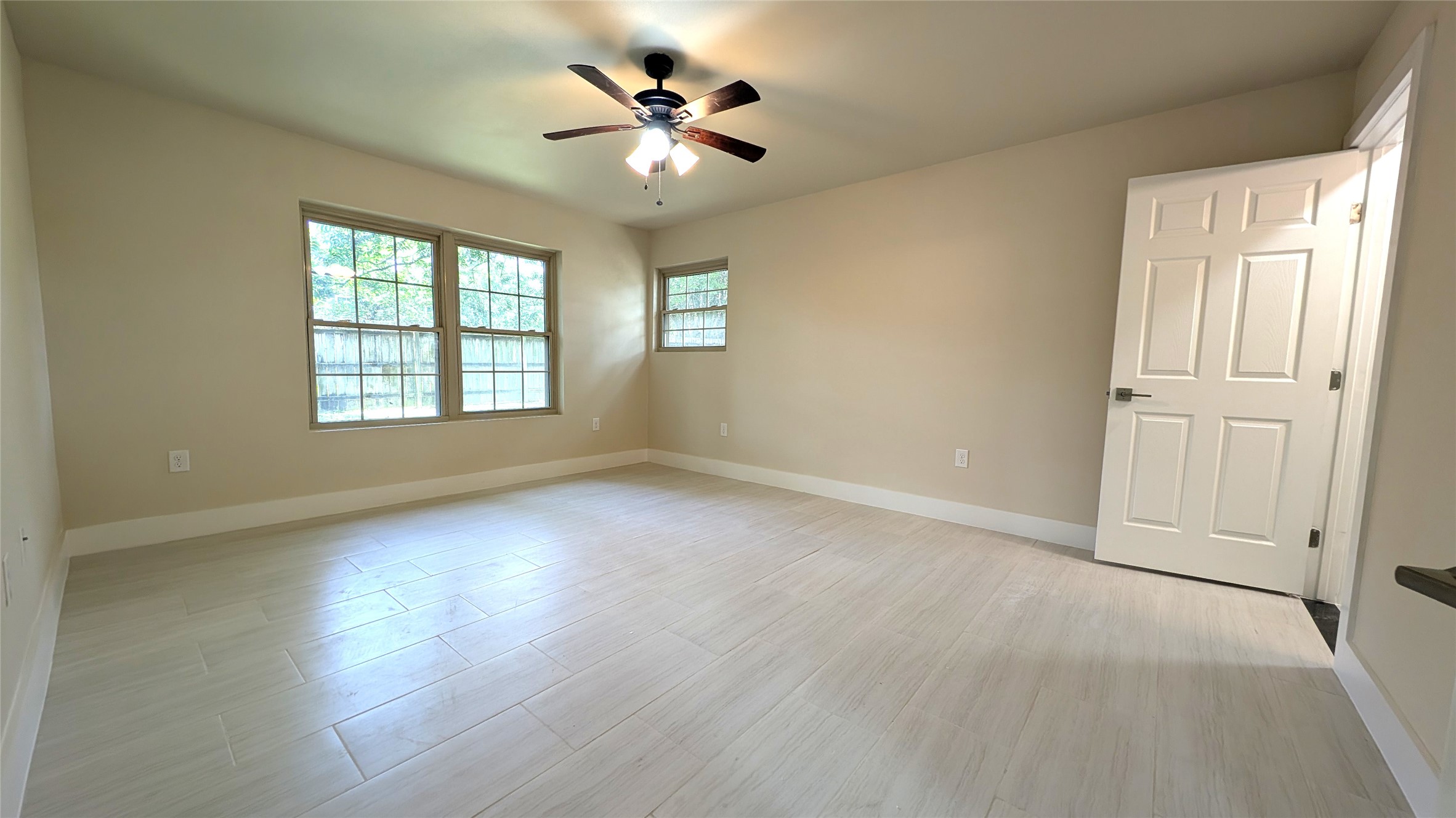 11811 Sleepy Hollow Road Manchaca, TX 78652 - Photo 13 of 31 an empty room with wooden floor chandelier fan and windows