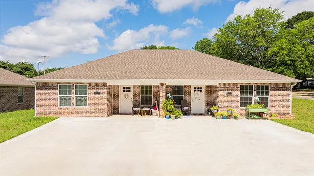 a view of a house with sitting area and garden