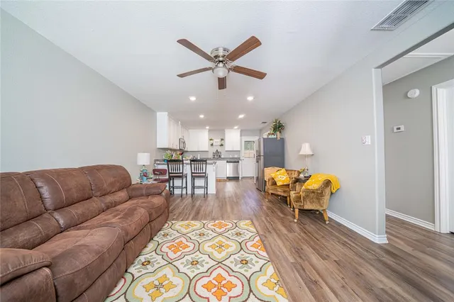a living room with furniture and kitchen view