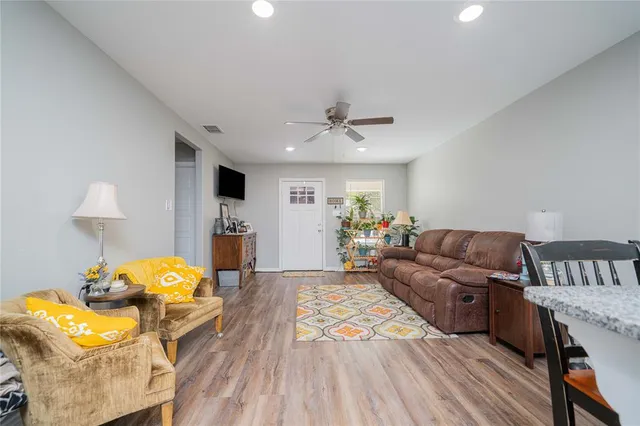 a living room with furniture and wooden floor