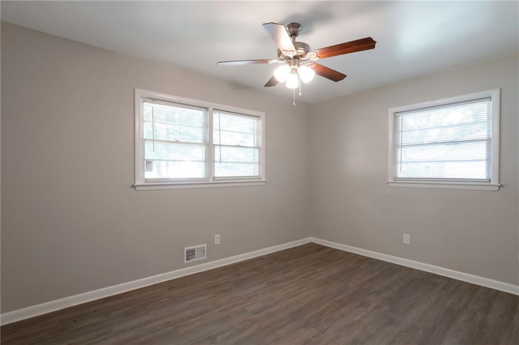 904 Pine Roc Drive Stone Mountain, GA 30083 - Photo 11 of 15 a view of a room with wooden floor and windows