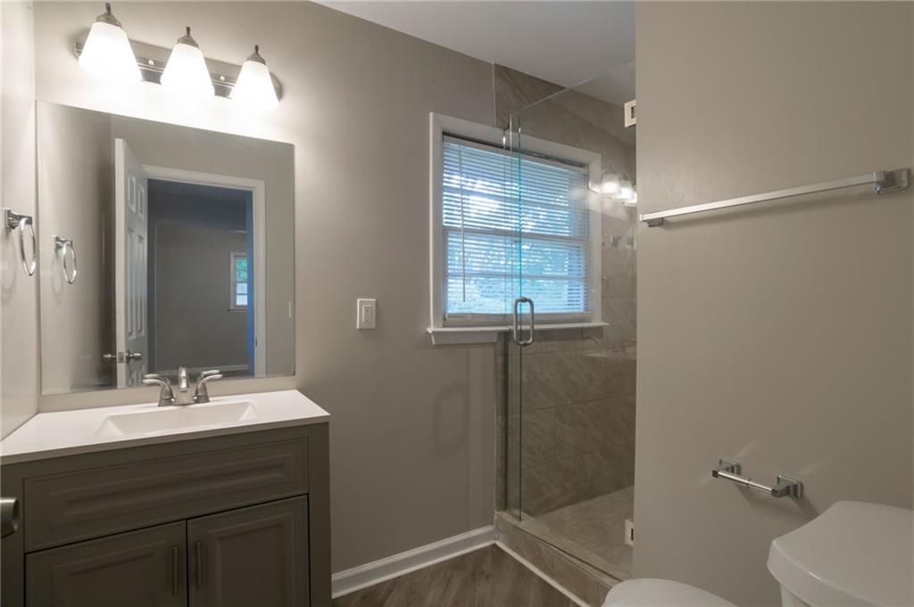 904 Pine Roc Drive Stone Mountain, GA 30083 - Photo 13 of 15 a bathroom with a sink a toilet and shower