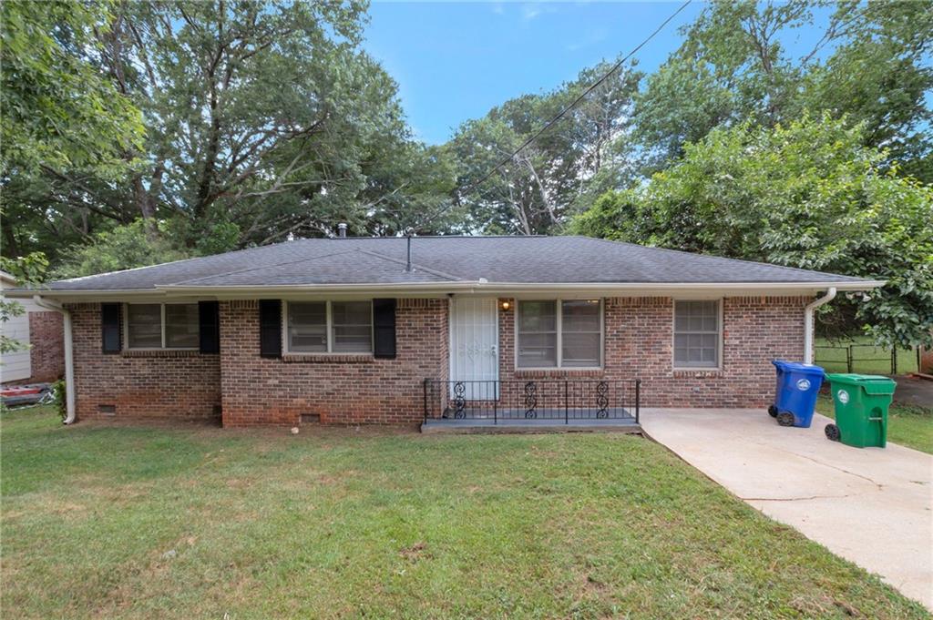 904 Pine Roc Drive Stone Mountain, GA 30083 - Photo 2 of 15 a front view of a house with garden