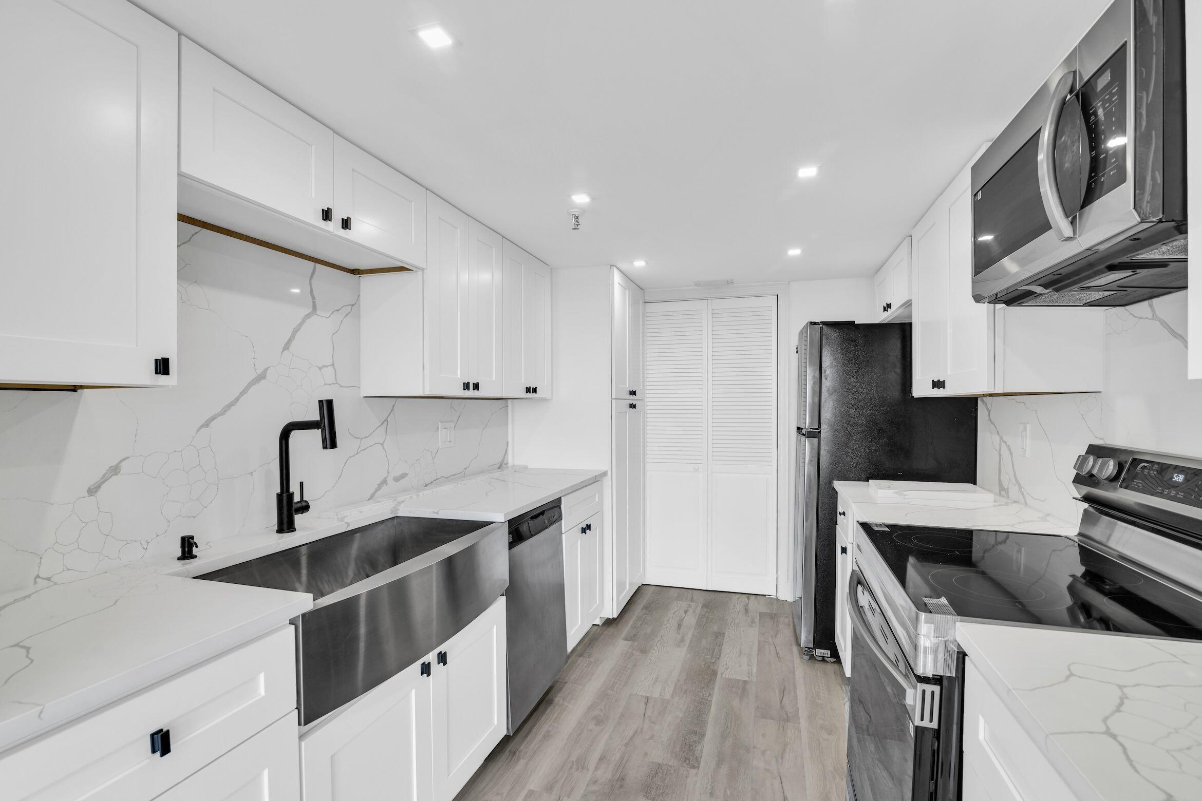 a kitchen with stainless steel appliances a sink stove and refrigerator